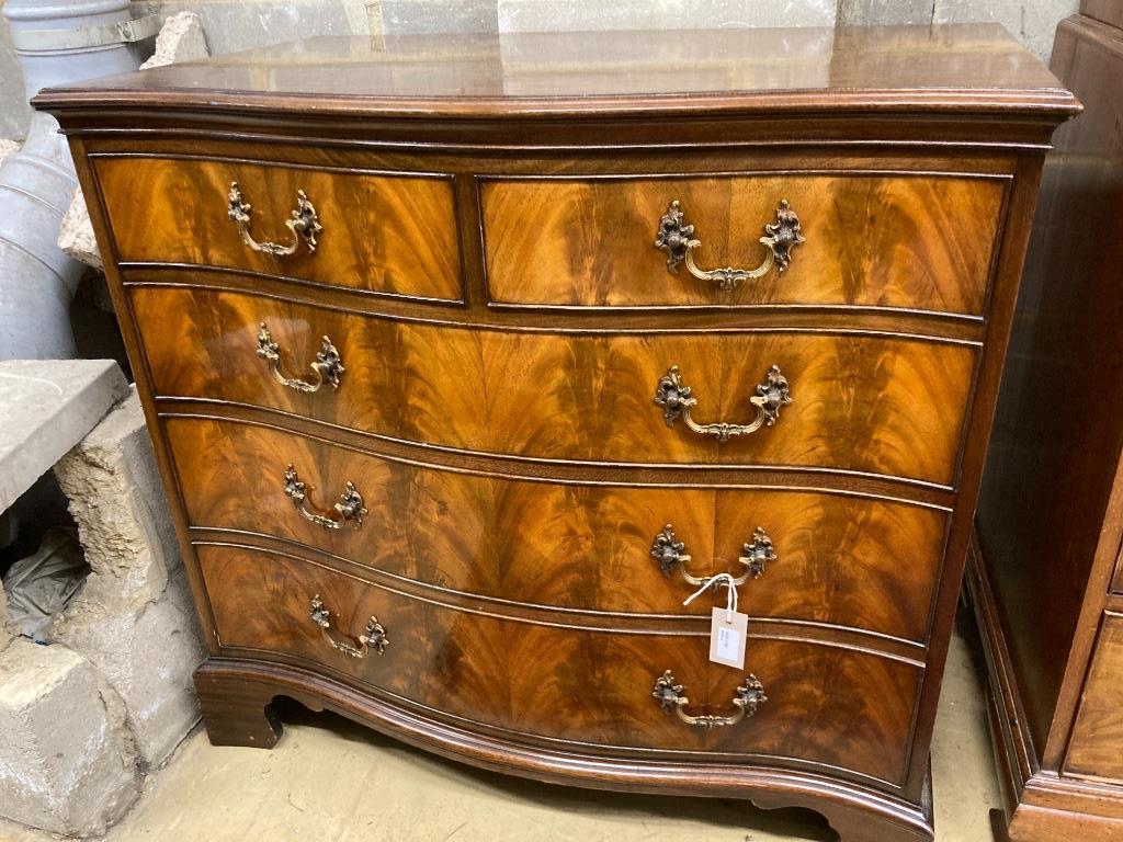 A George III style mahogany serpentine chest